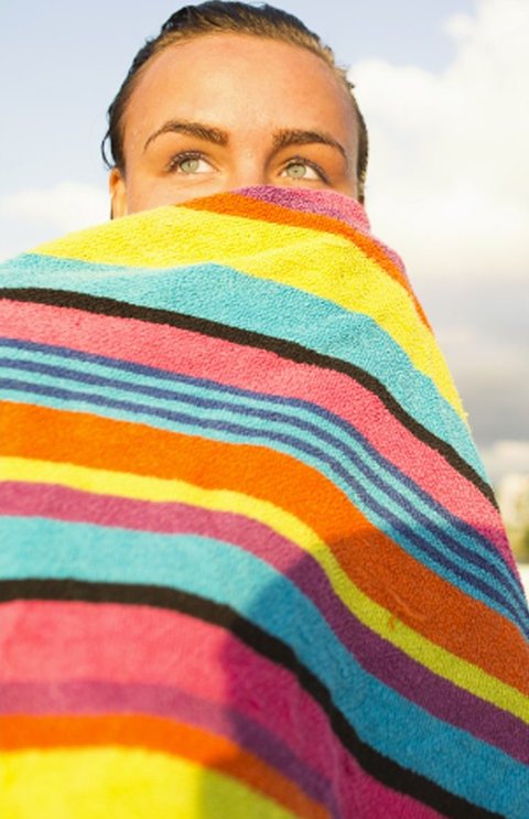 A woman wrapped in a striped beach towel